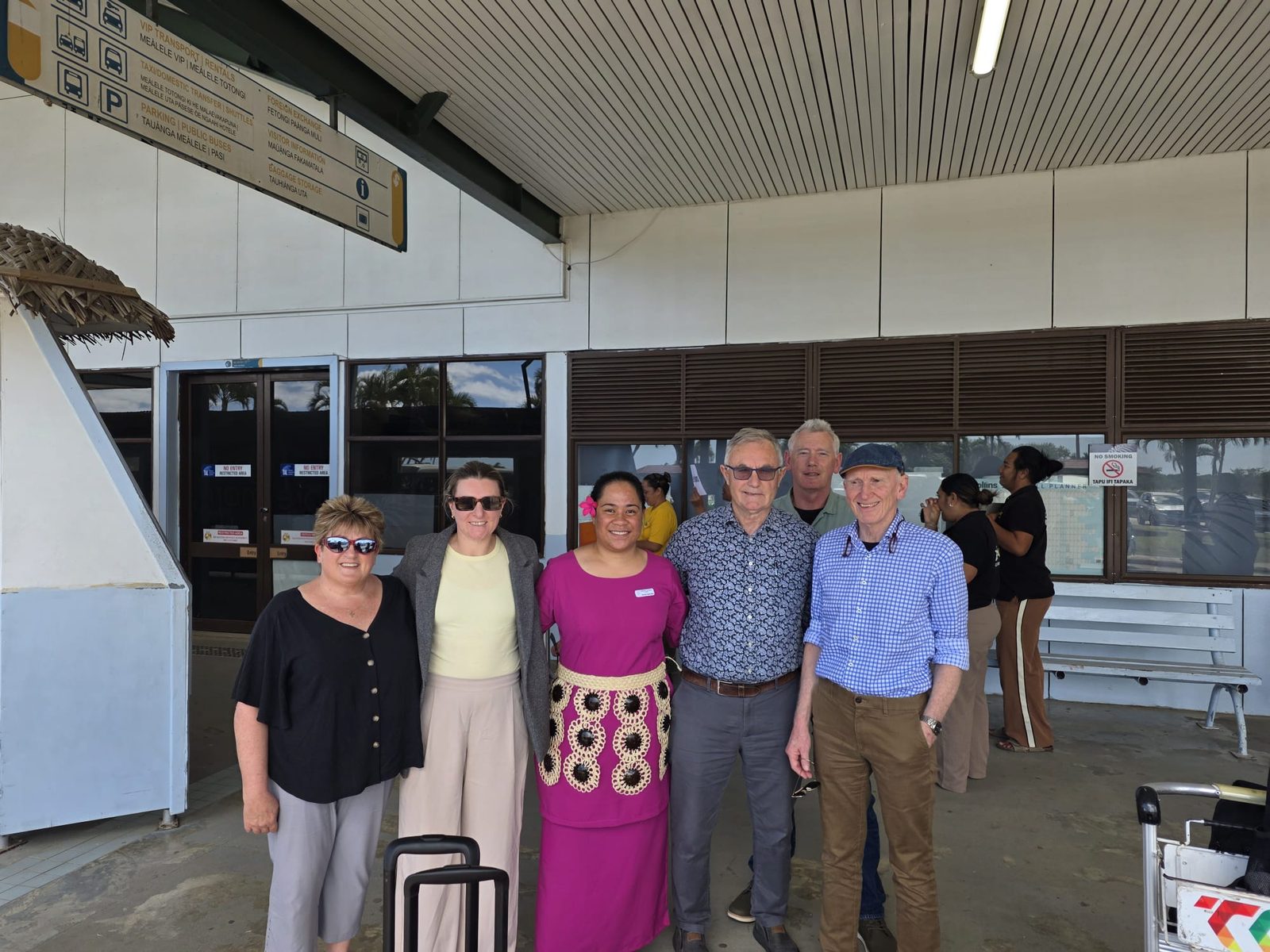 The visiting New Zealand surgical team with a Tongan representative outside the airport terminal in Tonga